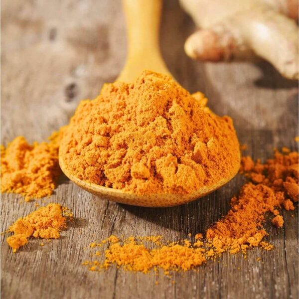 Premium ground turmeric powder from Brazil in a wooden spoon